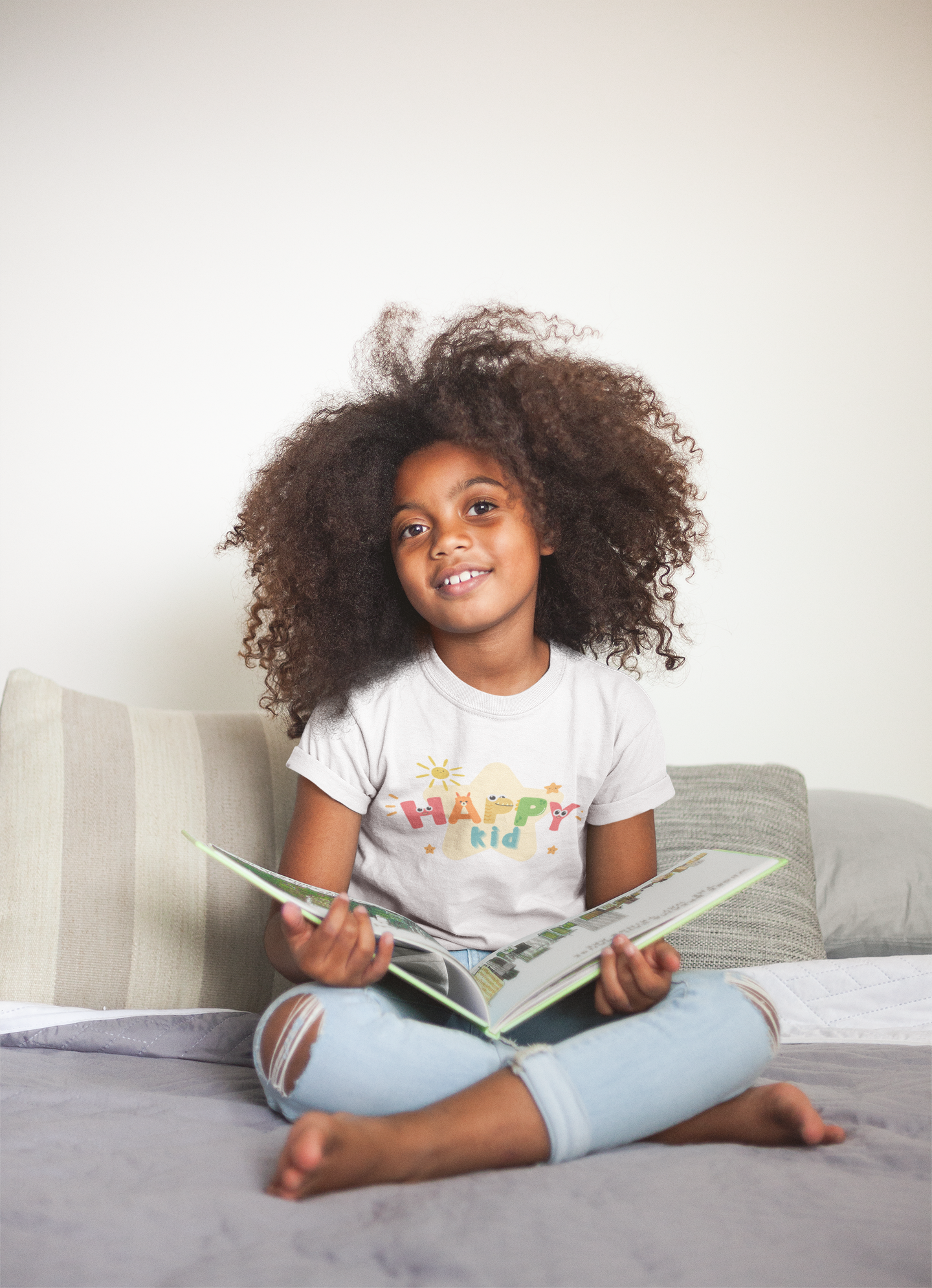 mockup-of-a-little-black-girl-wearing-a-t-shirt-while-reading-a21320