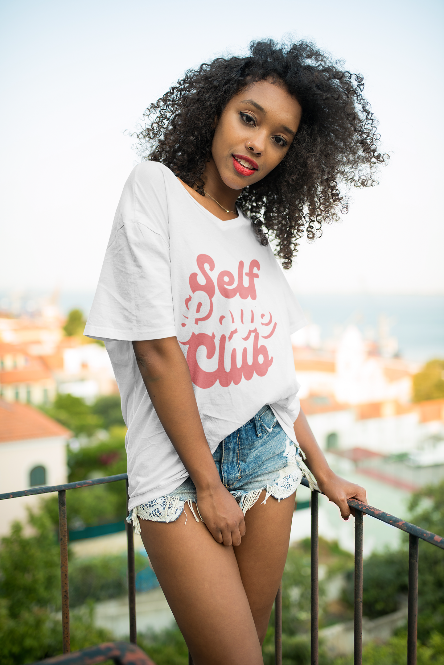 mockup-of-a-woman-with-a-unisex-t-shirt-posing-at-a-balcony-35197-r-el2